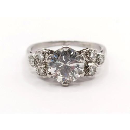 426 - A platinum and diamond ring, the central stone approx. 1.65ct, with further diamonds to the shoulder... 