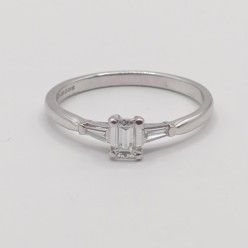 427 - An 18ct white gold and solitaire emerald cut diamond ring, ring size N