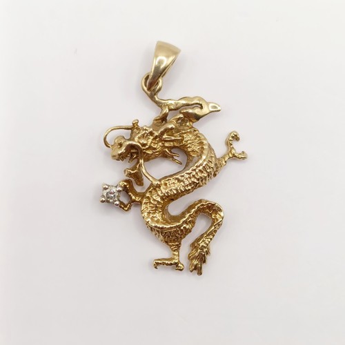 434 - A 9ct gold and diamond pendant, in the form of a dragon