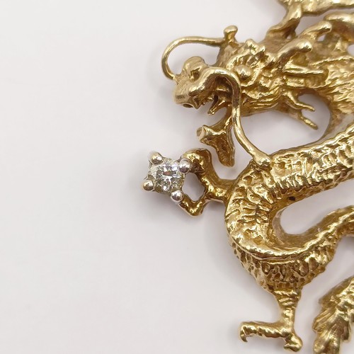 434 - A 9ct gold and diamond pendant, in the form of a dragon