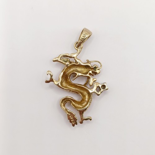 434 - A 9ct gold and diamond pendant, in the form of a dragon