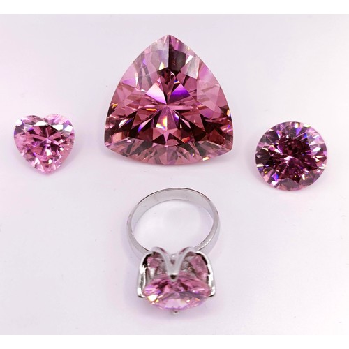 436 - A large man made pink gemstone, 30.6 g, two smaller, and a silver ring inset with a pink stone (4)