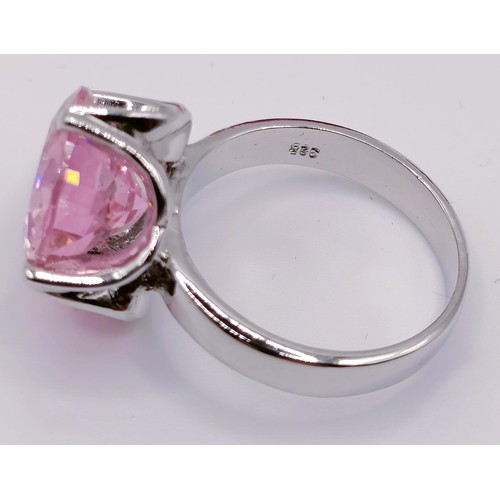 436 - A large man made pink gemstone, 30.6 g, two smaller, and a silver ring inset with a pink stone (4)