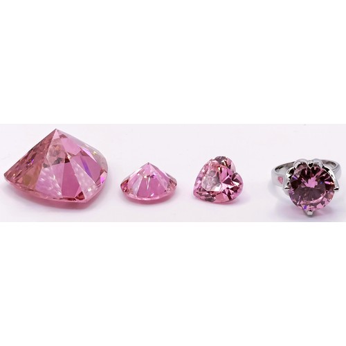 436 - A large man made pink gemstone, 30.6 g, two smaller, and a silver ring inset with a pink stone (4)