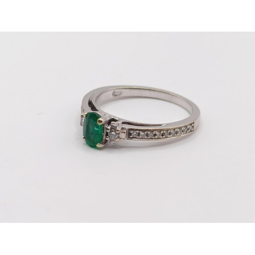 438 - An 18ct white gold, emerald and diamond ring, ring size J