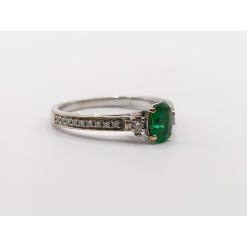 438 - An 18ct white gold, emerald and diamond ring, ring size J