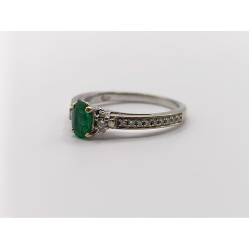 438 - An 18ct white gold, emerald and diamond ring, ring size J