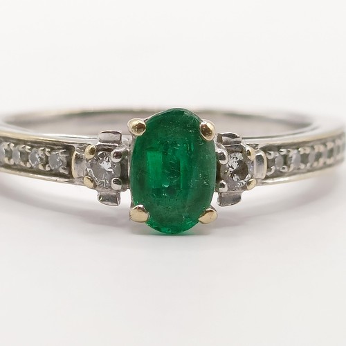 438 - An 18ct white gold, emerald and diamond ring, ring size J