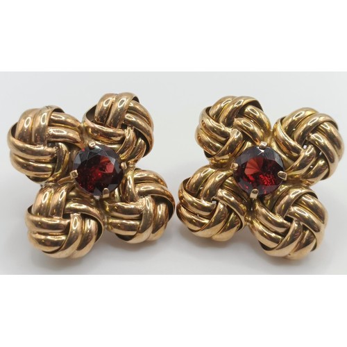 439 - A pair of yellow metal and garnet clip on earrings