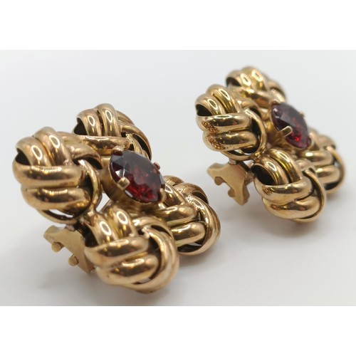 439 - A pair of yellow metal and garnet clip on earrings