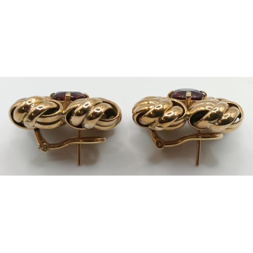 439 - A pair of yellow metal and garnet clip on earrings