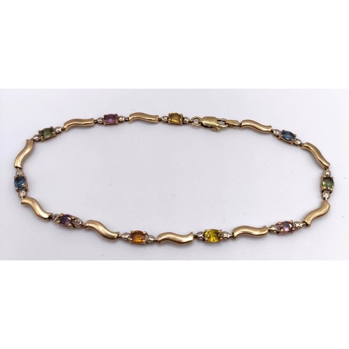 440 - A yellow coloured metal and multi-coloured stone bracelet