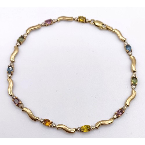 440 - A yellow coloured metal and multi-coloured stone bracelet