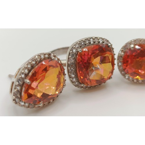 445 - A silver, orange and white stone ring, ring size M, and a pair of matching earrings (3)