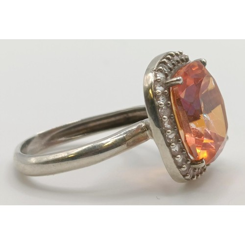 445 - A silver, orange and white stone ring, ring size M, and a pair of matching earrings (3)