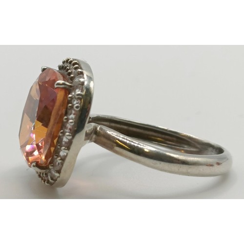 445 - A silver, orange and white stone ring, ring size M, and a pair of matching earrings (3)