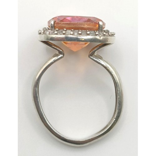 445 - A silver, orange and white stone ring, ring size M, and a pair of matching earrings (3)