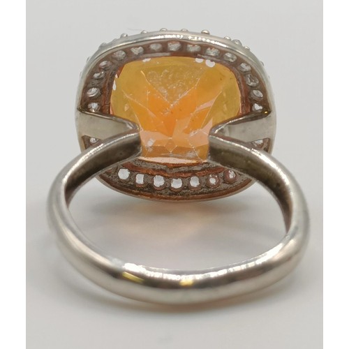 445 - A silver, orange and white stone ring, ring size M, and a pair of matching earrings (3)