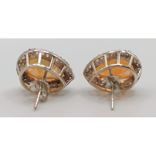 445 - A silver, orange and white stone ring, ring size M, and a pair of matching earrings (3)