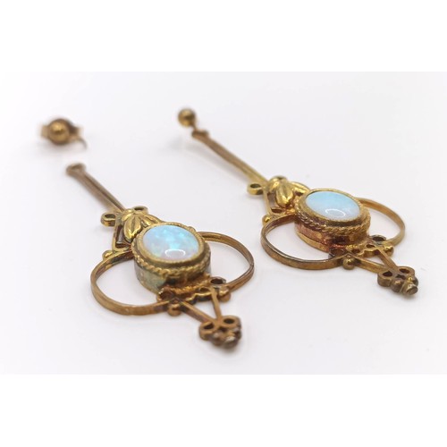 447 - A pair of Indian yellow coloured metal and opal drop earrings