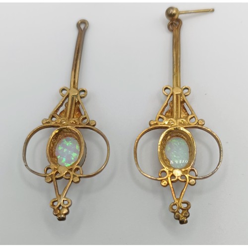 447 - A pair of Indian yellow coloured metal and opal drop earrings