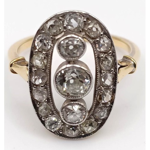 457 - A late 19th/early 20th century diamond cluster ring, with three central stones, surrounded by an ova... 