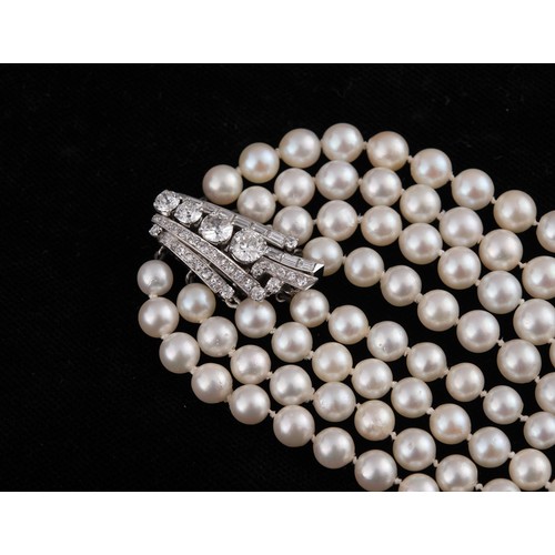 301 - A four strand cultured pearl necklace, with an impressive diamond clasp, the largest diamond approx.... 