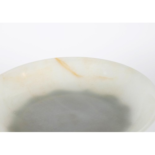 800 - A Chinese jade bowl, of shallow form, bearing a Chia-Ching (1796-1820) incised four character mark t... 