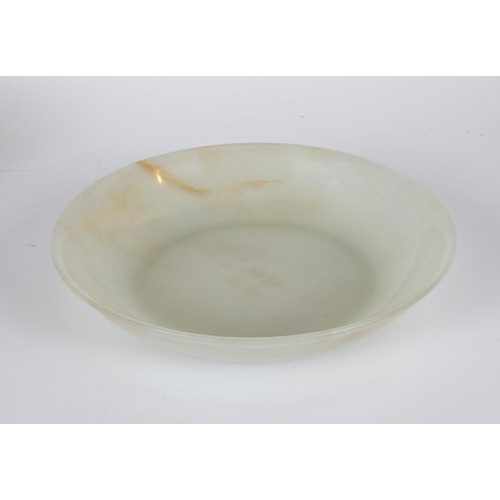 800 - A Chinese jade bowl, of shallow form, bearing a Chia-Ching (1796-1820) incised four character mark t... 