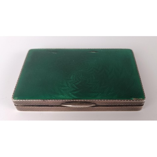 74 - A silver and green enamel snuff box, 8 cm wide