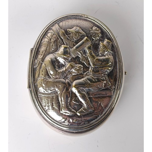 133 - A Dutch silver coloured metal oval tobacco box, the lid decorated a tavern scene, 10 cm wide