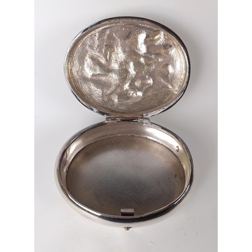 133 - A Dutch silver coloured metal oval tobacco box, the lid decorated a tavern scene, 10 cm wide