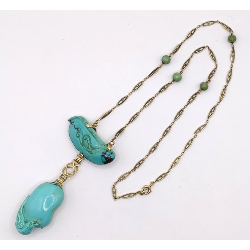 367 - A 14ct gold and carved turquoise bird pendant, on a chain