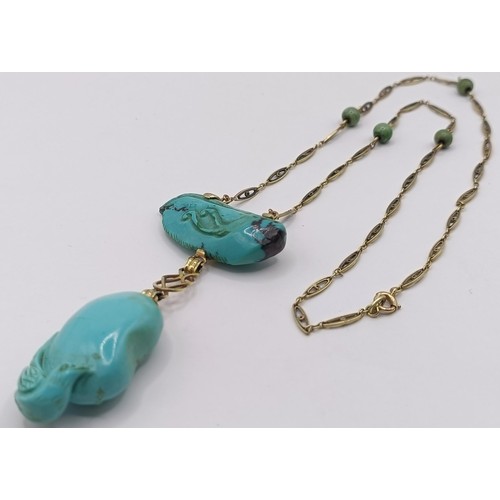 367 - A 14ct gold and carved turquoise bird pendant, on a chain