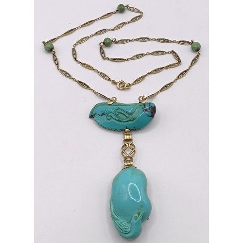 367 - A 14ct gold and carved turquoise bird pendant, on a chain