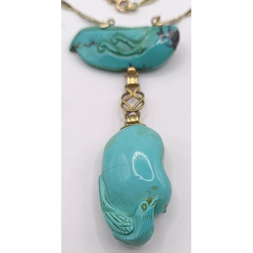 367 - A 14ct gold and carved turquoise bird pendant, on a chain