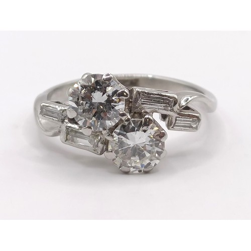 377 - An Art Deco platinum and diamond crossover ring, ring size K