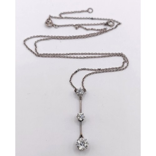 387 - A three stone diamond pendant, on a chain