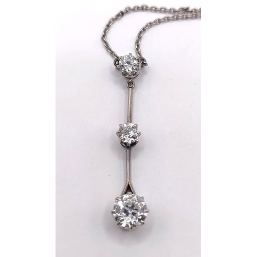 387 - A three stone diamond pendant, on a chain