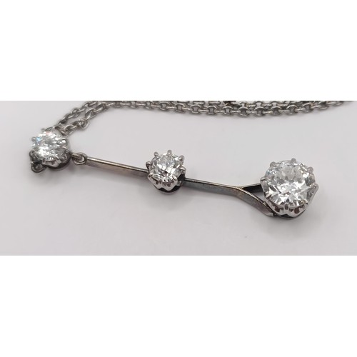 387 - A three stone diamond pendant, on a chain