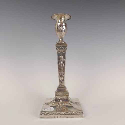 34 - A pair of George III silver candlesticks, decorated figures, loaded, Sheffield 1776, 30 cm high...