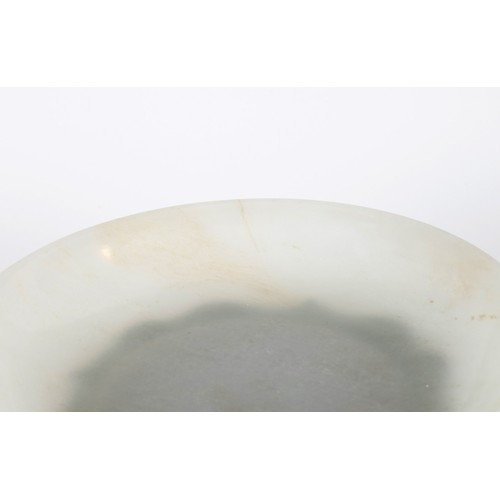 800 - A Chinese jade bowl, of shallow form, bearing a Chia-Ching (1796-1820) incised four character mark t... 