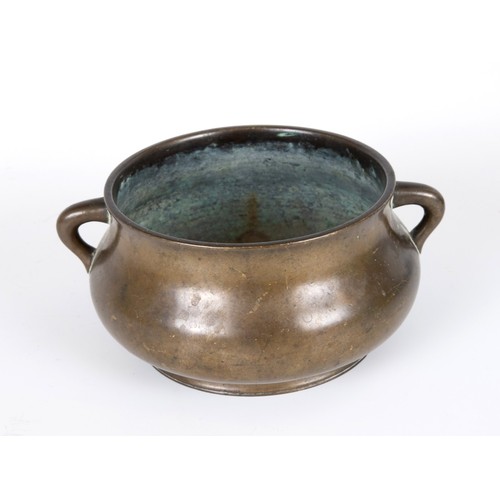 803 - A Chinese bronze censer, of compressed circular form and with twin handles, character mark to base, ... 