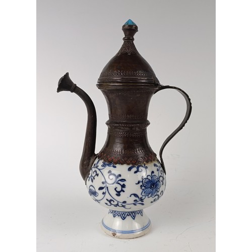 993 - A Moorish style ewer, the porcelain body decorated in underglaze blue and with metal mounts, 21 cm h... 