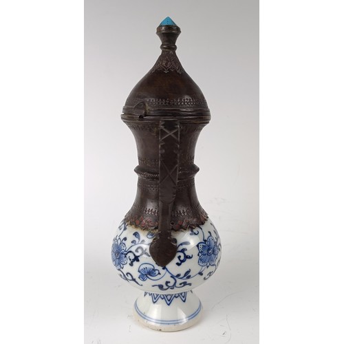 993 - A Moorish style ewer, the porcelain body decorated in underglaze blue and with metal mounts, 21 cm h... 