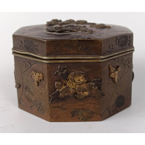 1001 - A Japanese bronze octagonal box, decorated butterflies and flowers, lacking base, 6.5 cm wide...