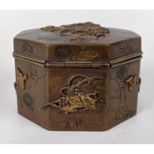 1001 - A Japanese bronze octagonal box, decorated butterflies and flowers, lacking base, 6.5 cm wide