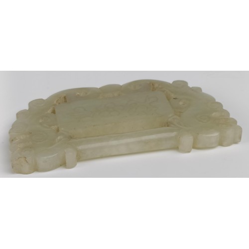 1007 - A Chinese pale green stone carved plaque, 8 x 4 cm