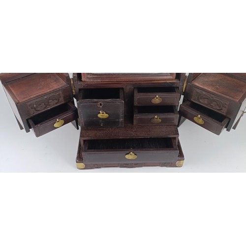 1009 - A Chinese hardwood and metal bound dressing chest, 23 cm wide