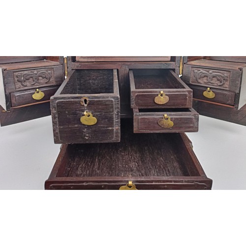 1009 - A Chinese hardwood and metal bound dressing chest, 23 cm wide